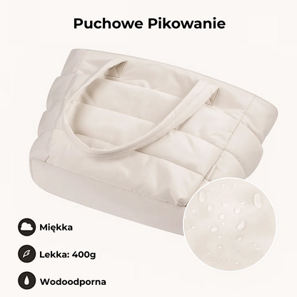„Beżowa torba Softi z puchowym pikowaniem; ikony opisują ją jako miękką, lekką i wodoodporną, a wstawka pokazuje krople wody na materiale.”